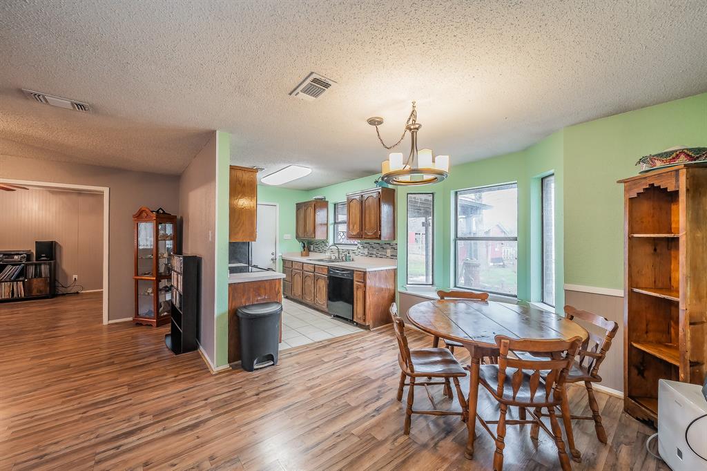 102 Perdue Circle Weatherford, TX 76085 - Photo 10 of 39 a view of a dining room with furniture and wooden floor