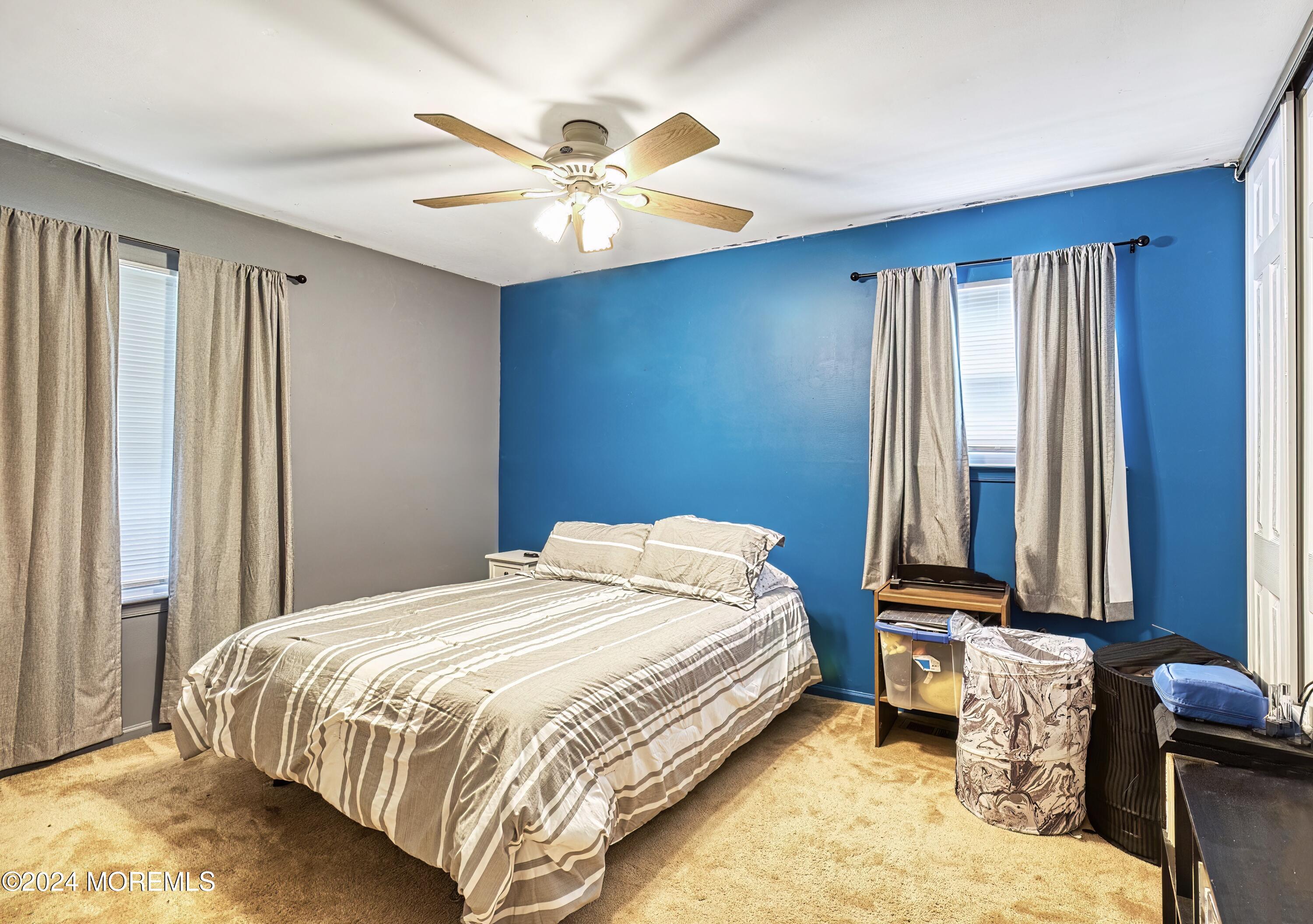34 Sweetbriar Trail Howell, NJ 07731 - Photo 17 of 53 a bedroom with a bed and a chandelier