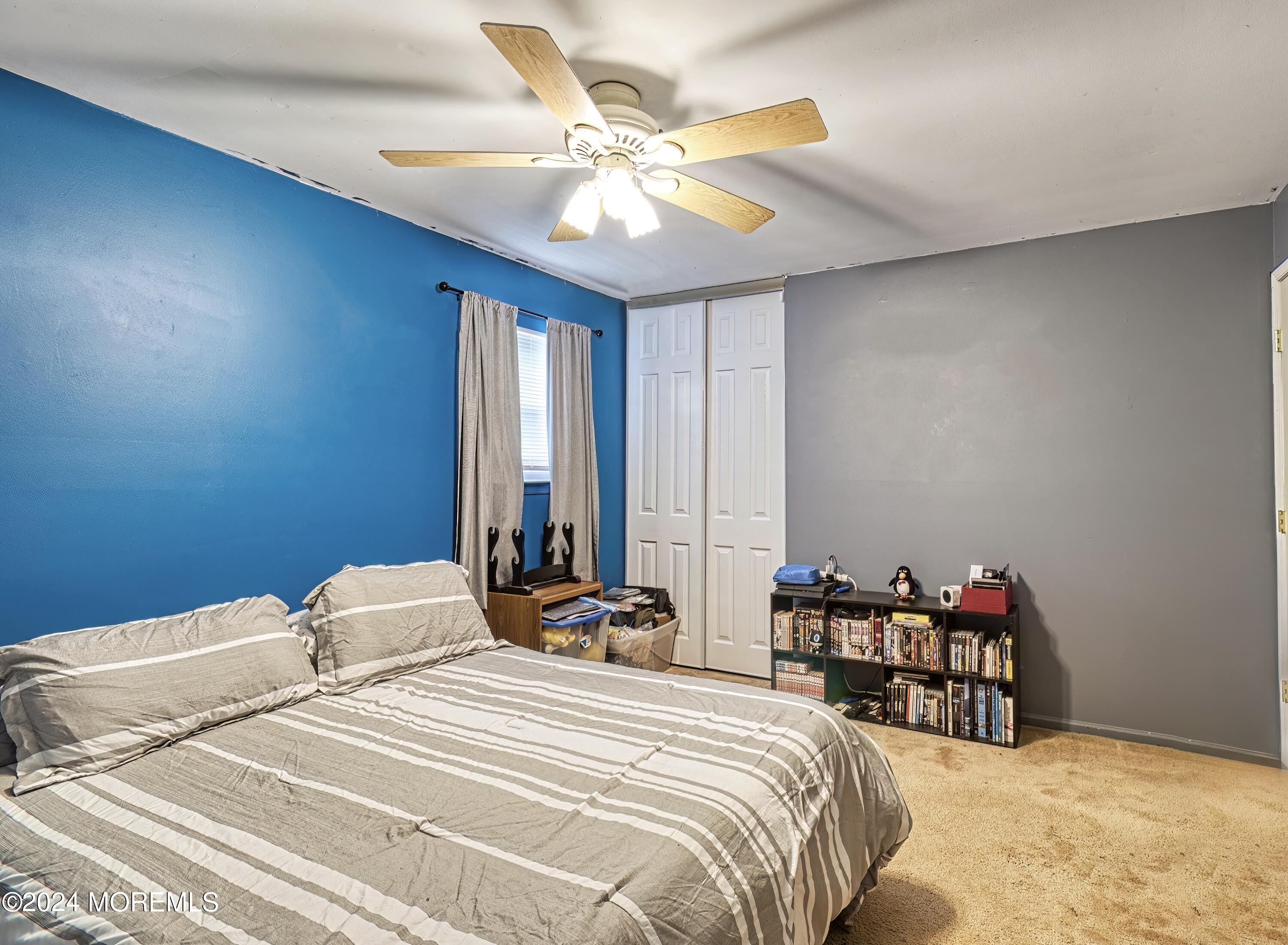 34 Sweetbriar Trail Howell, NJ 07731 - Photo 18 of 53 a bedroom with bed and a chandelier