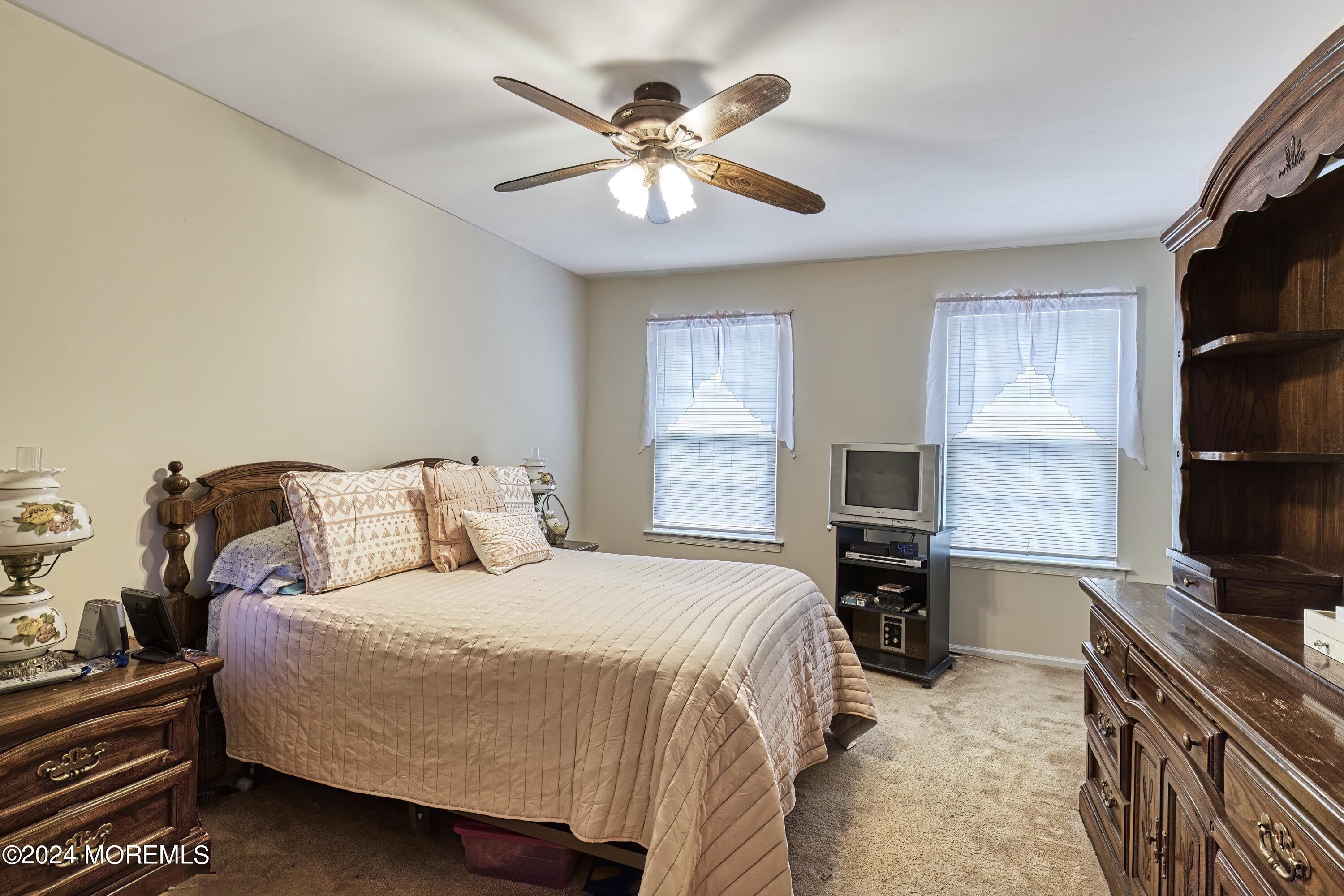 34 Sweetbriar Trail Howell, NJ 07731 - Photo 19 of 53 a bedroom with a bed and a desk