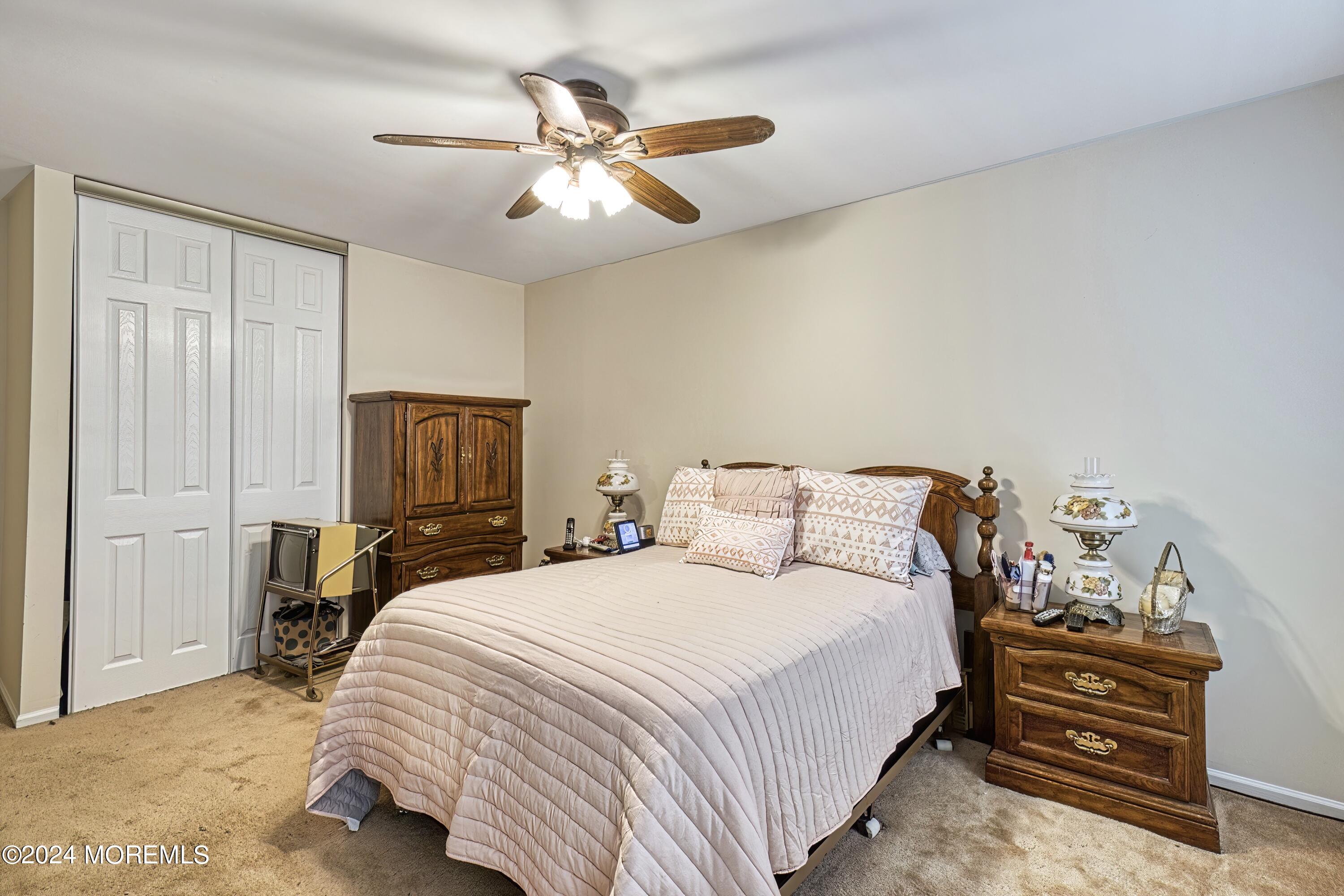 34 Sweetbriar Trail Howell, NJ 07731 - Photo 20 of 53 a bedroom with a bed and a chandelier
