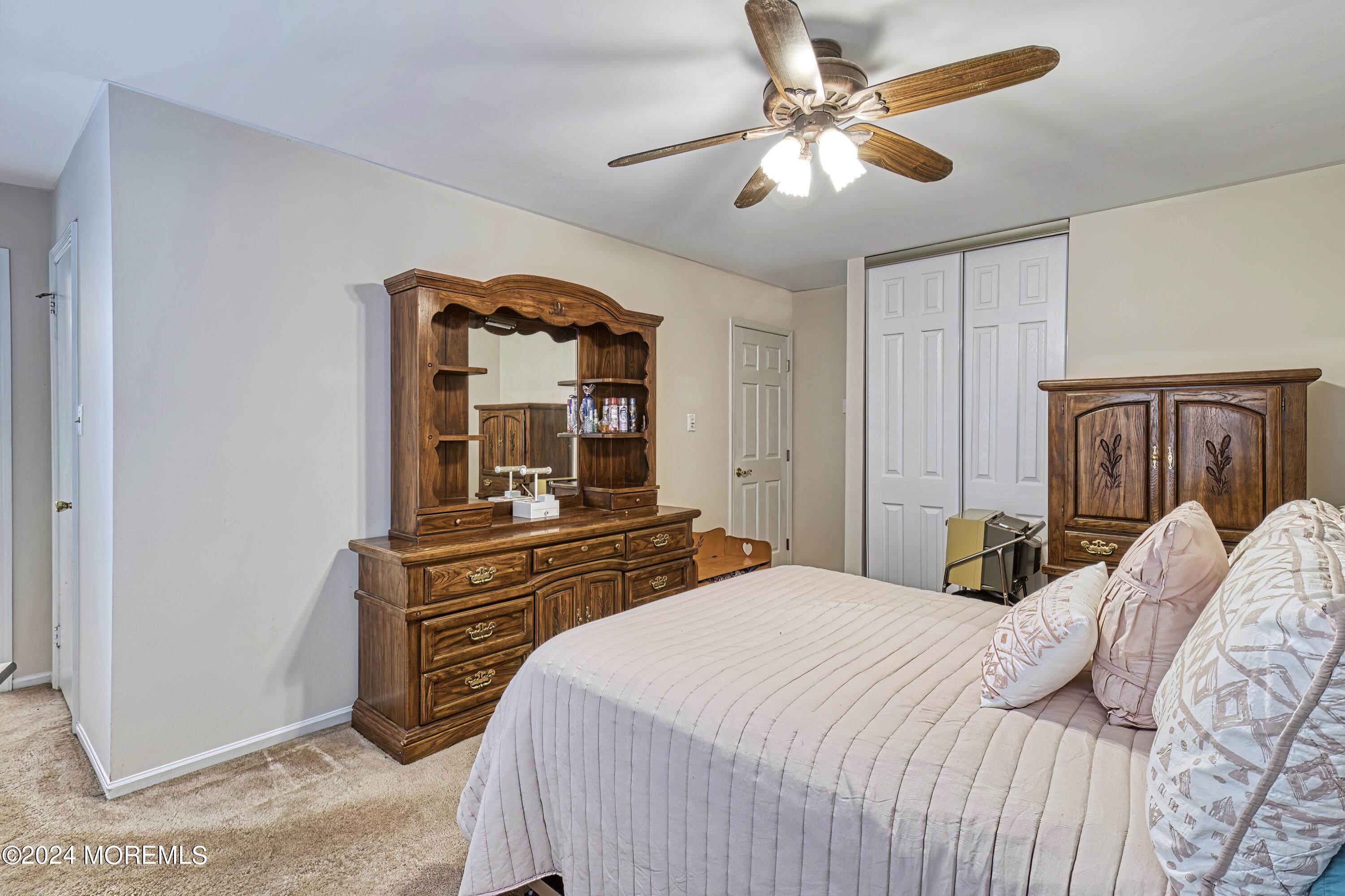 34 Sweetbriar Trail Howell, NJ 07731 - Photo 21 of 53 a bedroom with a bed and a chandelier
