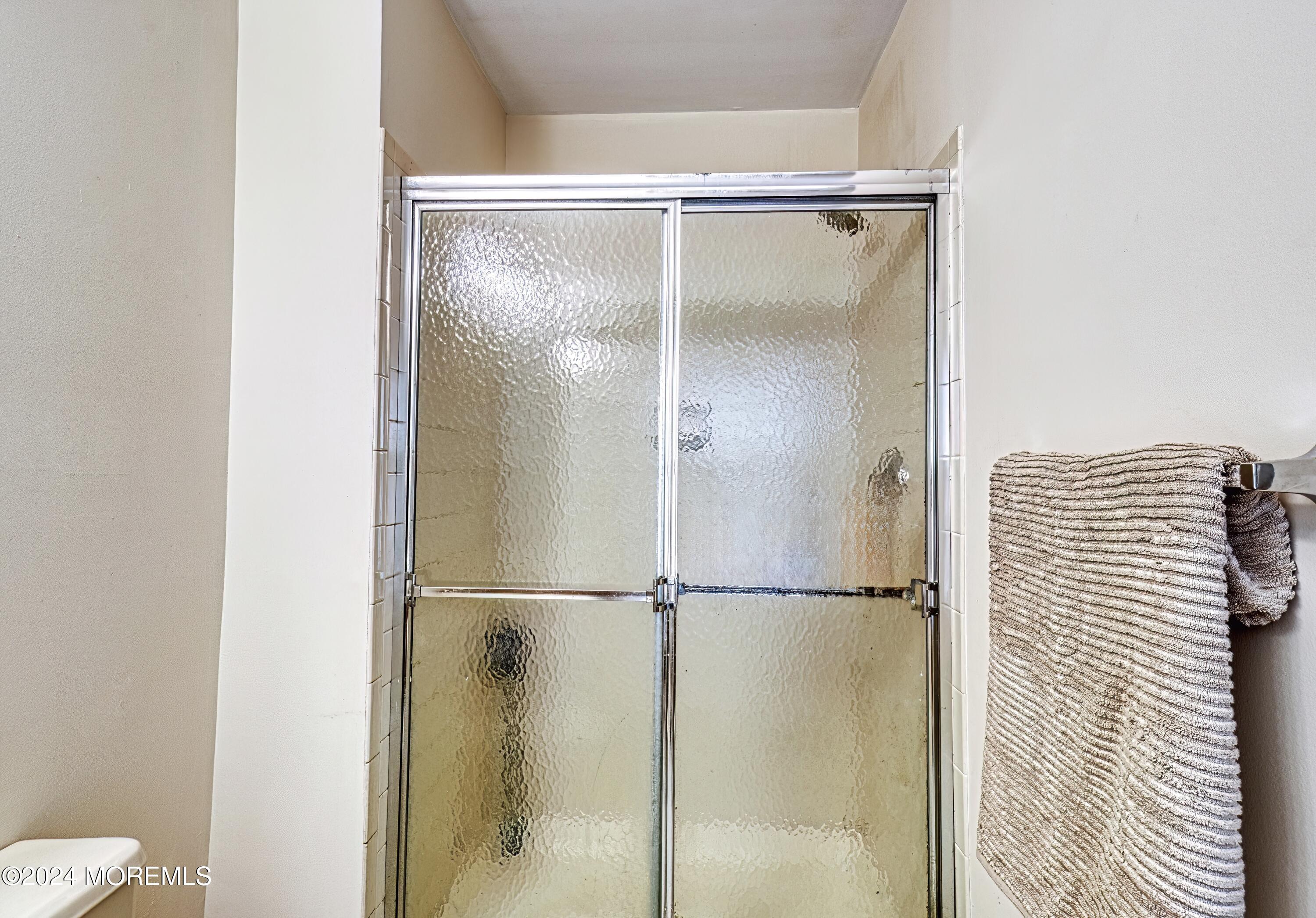 34 Sweetbriar Trail Howell, NJ 07731 - Photo 23 of 53 a bathroom with a glass shower door