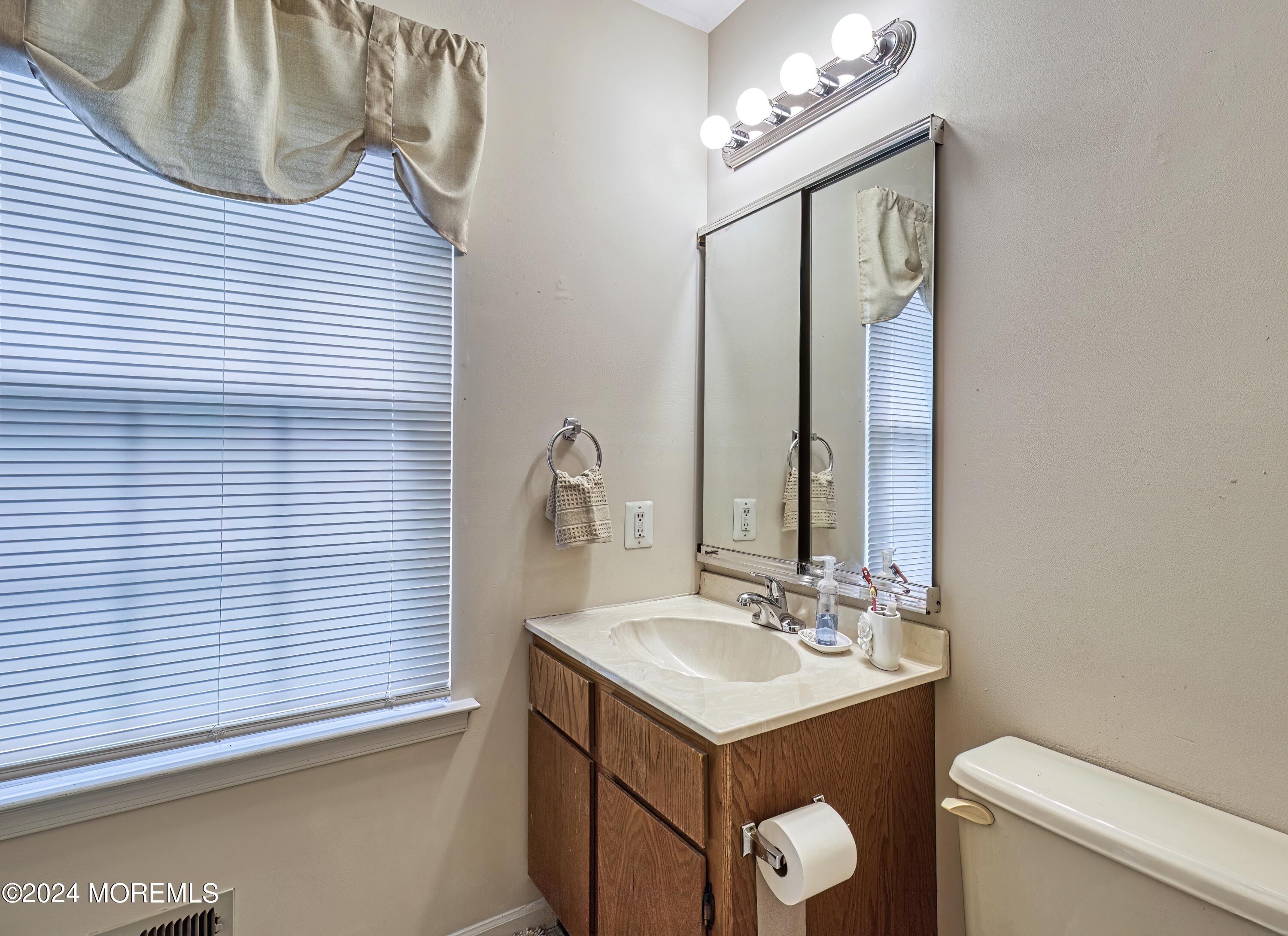 34 Sweetbriar Trail Howell, NJ 07731 - Photo 25 of 53 a bathroom with a sink mirror vanity and toilet