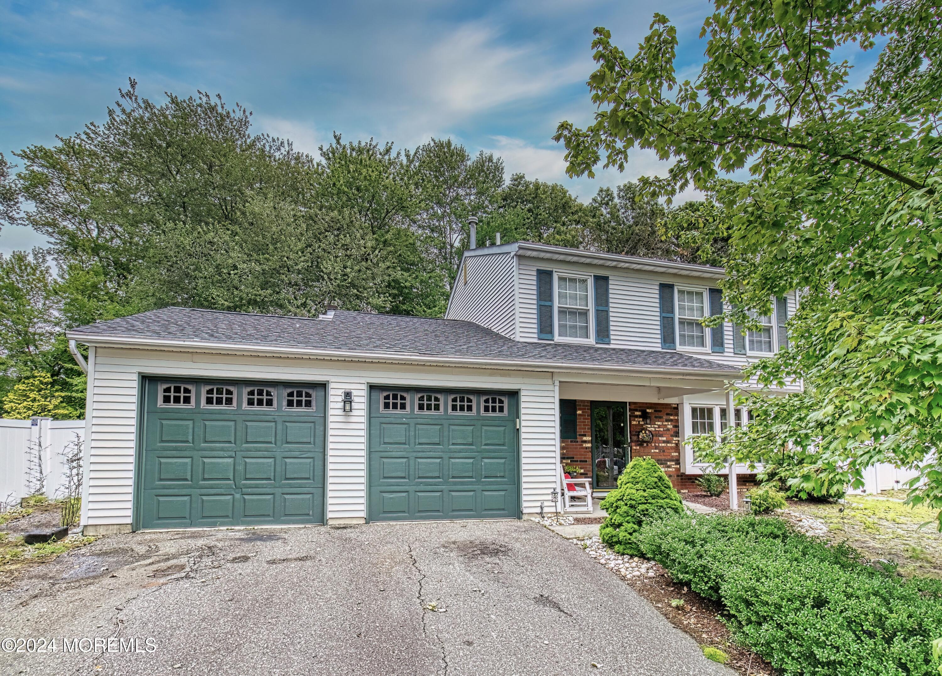 34 Sweetbriar Trail Howell, NJ 07731 - Photo 3 of 53 a front view of a house with a garden and garage