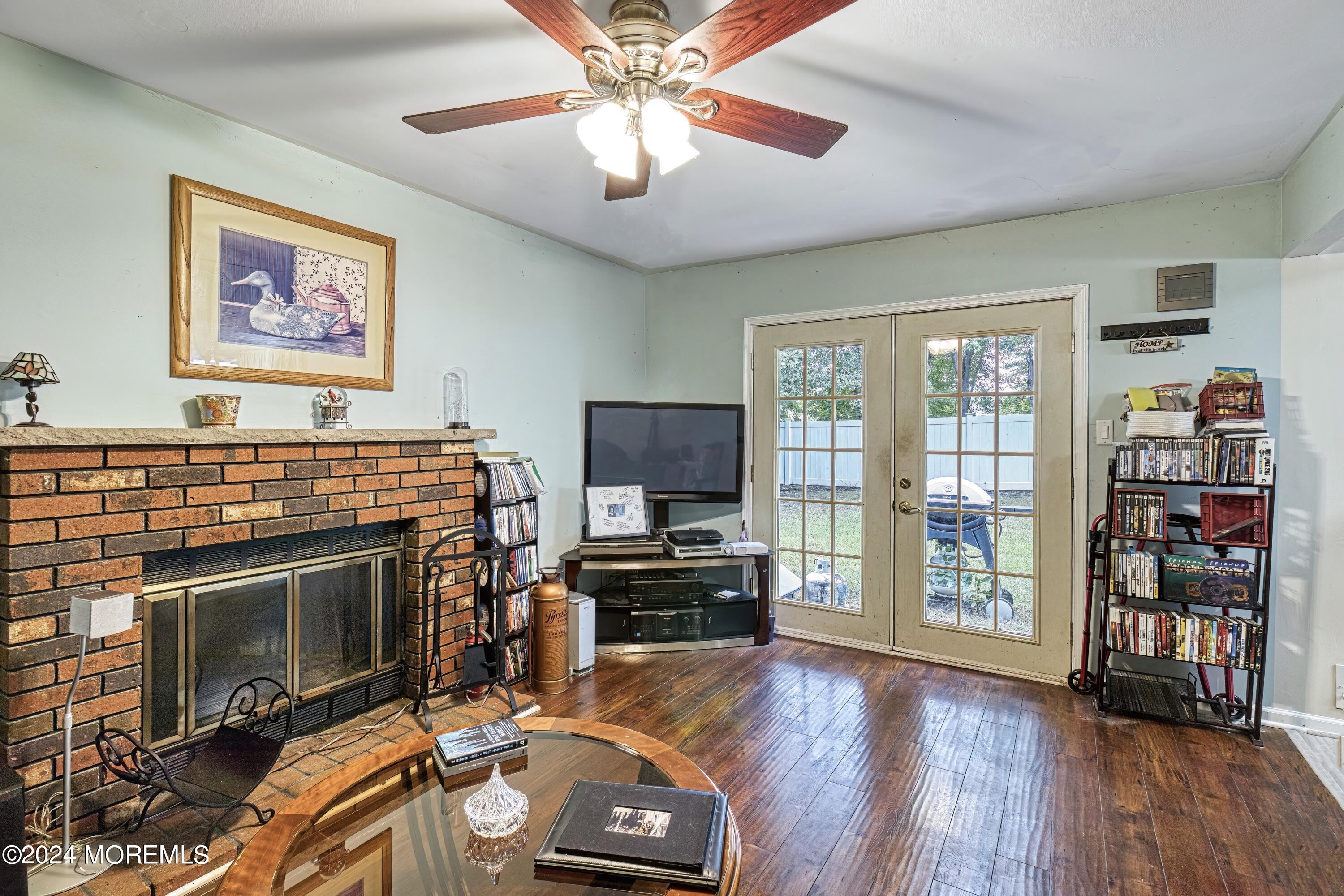 34 Sweetbriar Trail Howell, NJ 07731 - Photo 32 of 53 a living room with furniture a flat screen tv and a fireplace