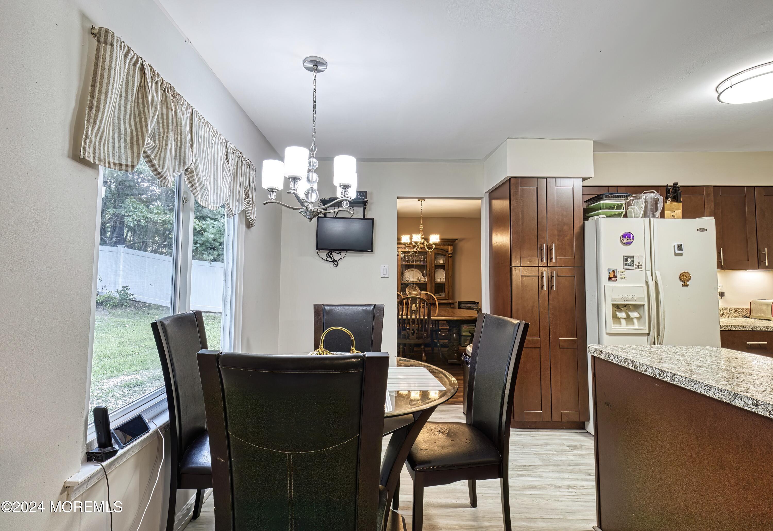 34 Sweetbriar Trail Howell, NJ 07731 - Photo 33 of 53 a dining room with furniture a chandelier and wooden floor