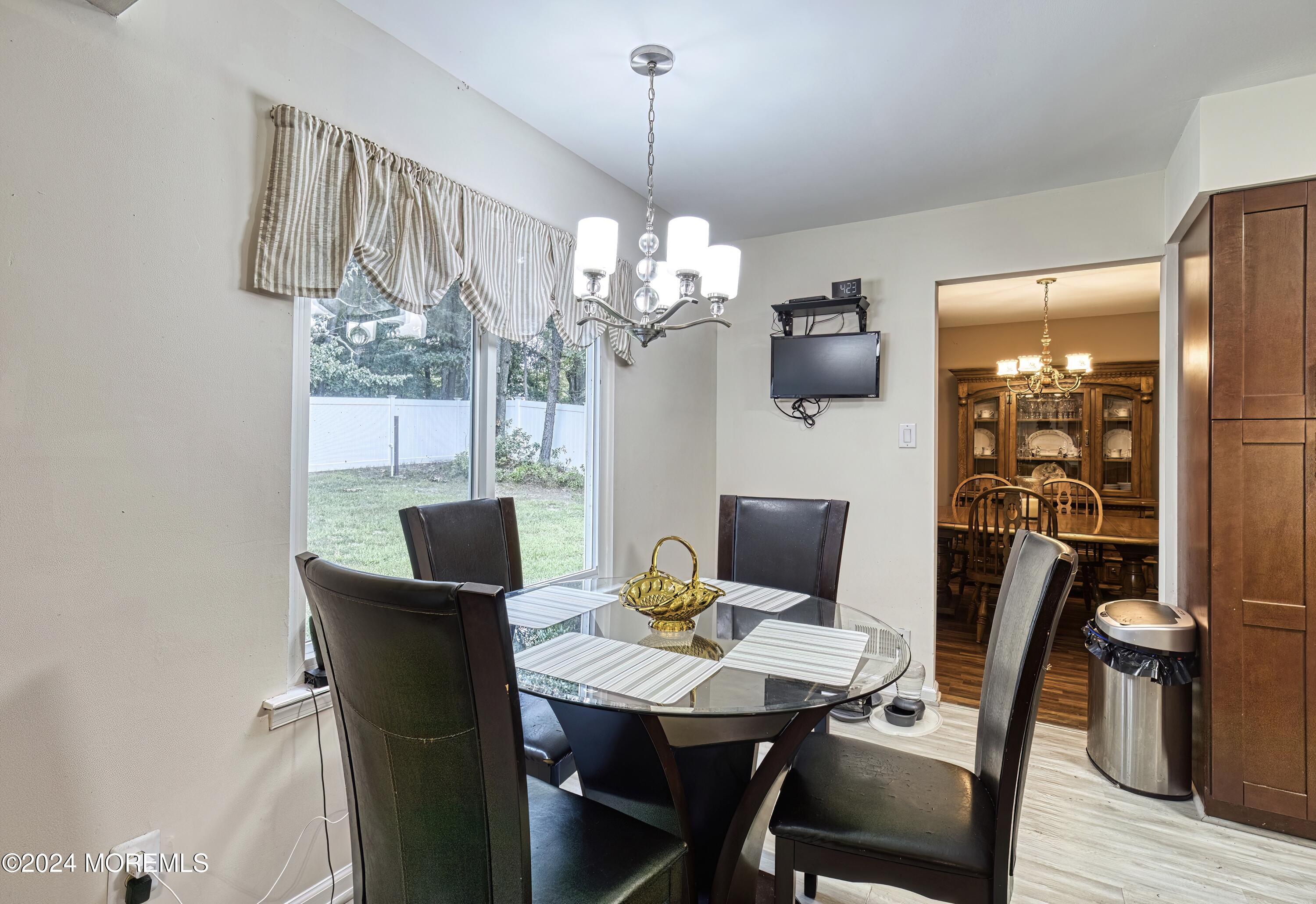 34 Sweetbriar Trail Howell, NJ 07731 - Photo 34 of 53 a view of a dining room with furniture wooden floor and chandelier