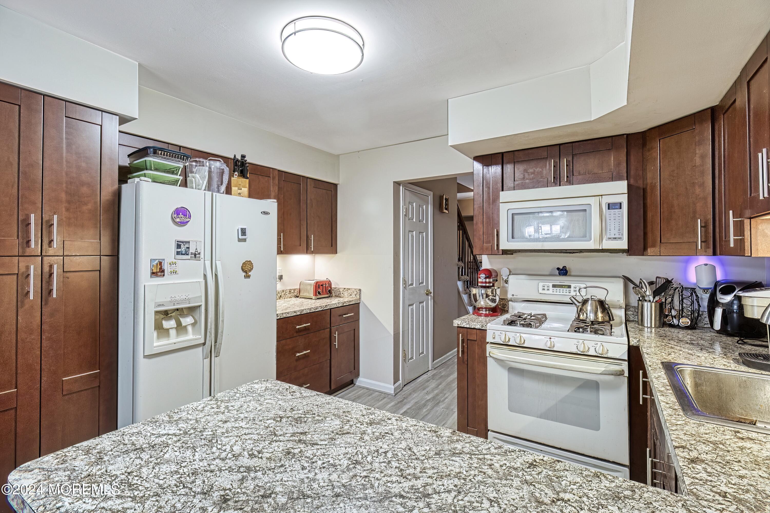 34 Sweetbriar Trail Howell, NJ 07731 - Photo 37 of 53 a kitchen with stainless steel appliances a refrigerator sink and stove