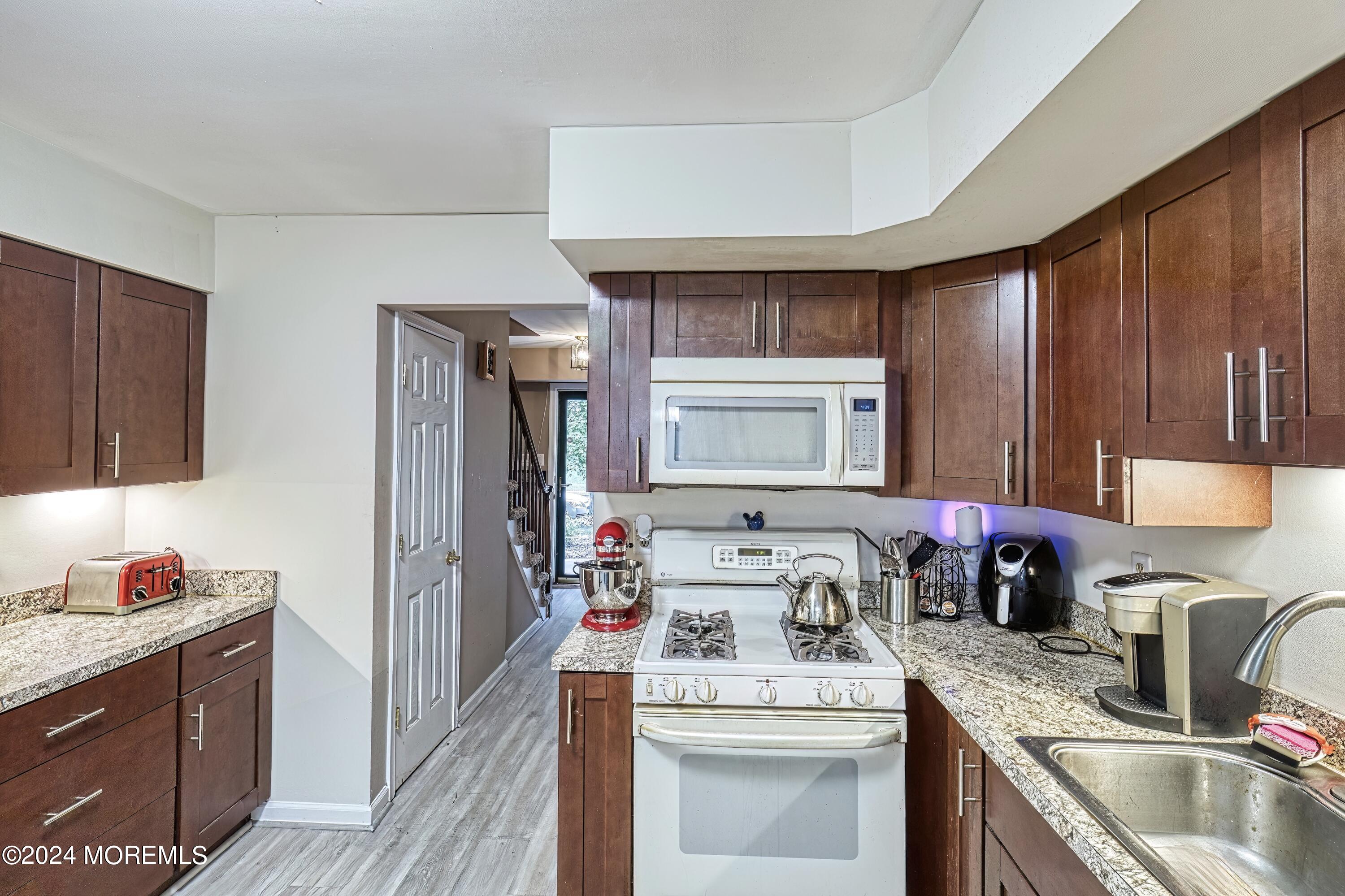 34 Sweetbriar Trail Howell, NJ 07731 - Photo 38 of 53 a kitchen with a sink stove and refrigerator