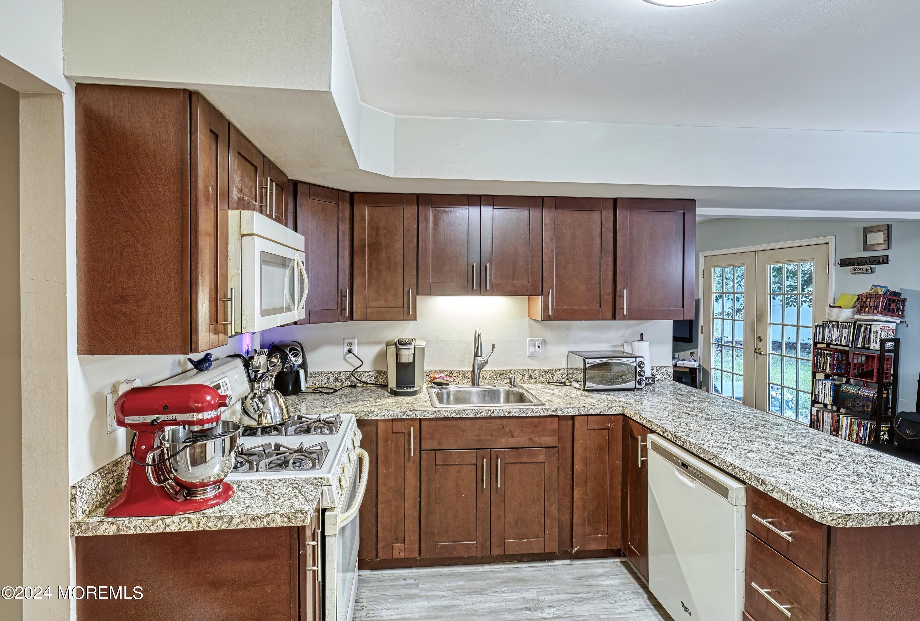 34 Sweetbriar Trail Howell, NJ 07731 - Photo 39 of 53 a kitchen with stainless steel appliances granite countertop a sink stove and cabinets
