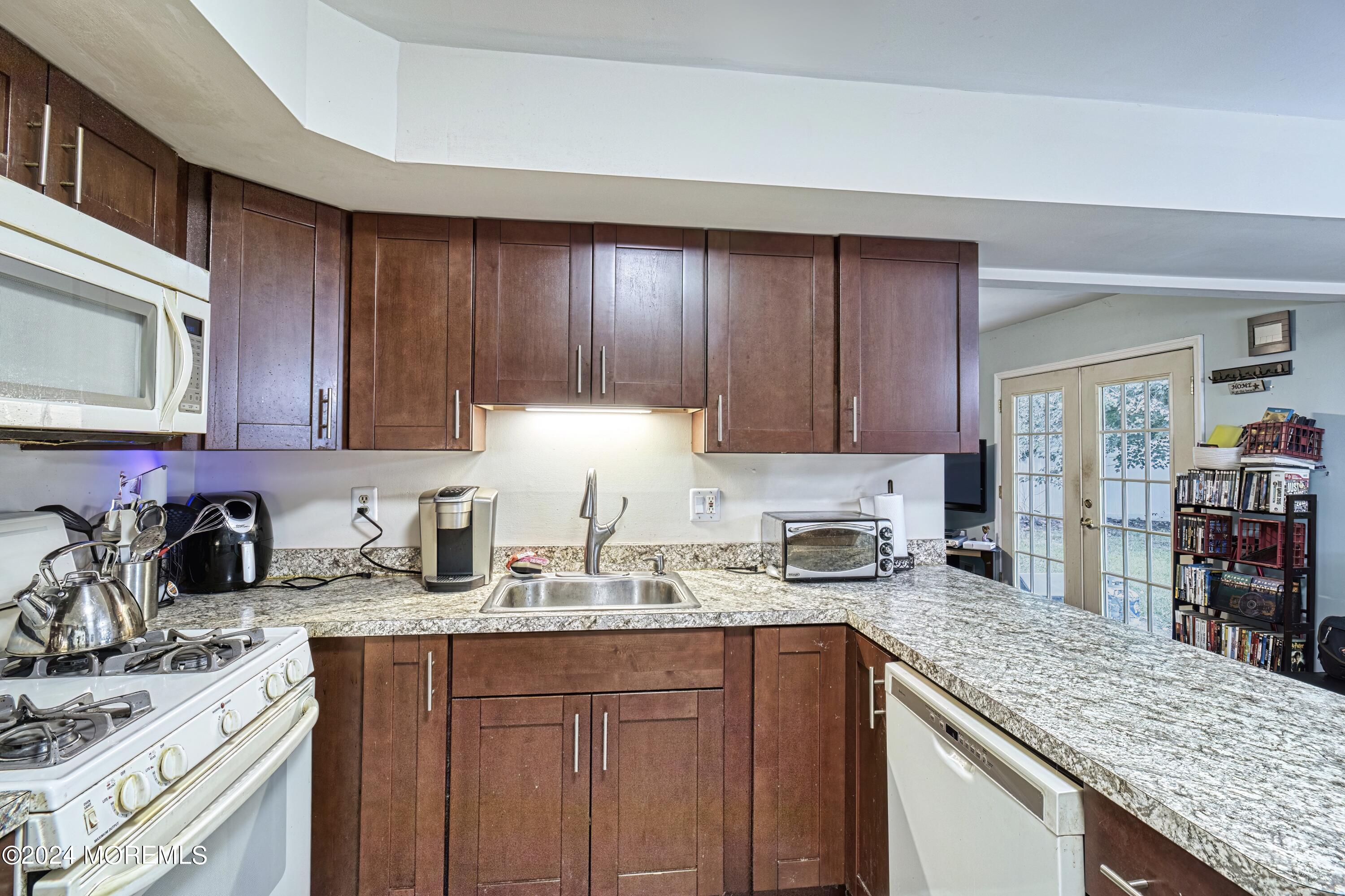 34 Sweetbriar Trail Howell, NJ 07731 - Photo 41 of 53 a kitchen with sink a stove and cabinets
