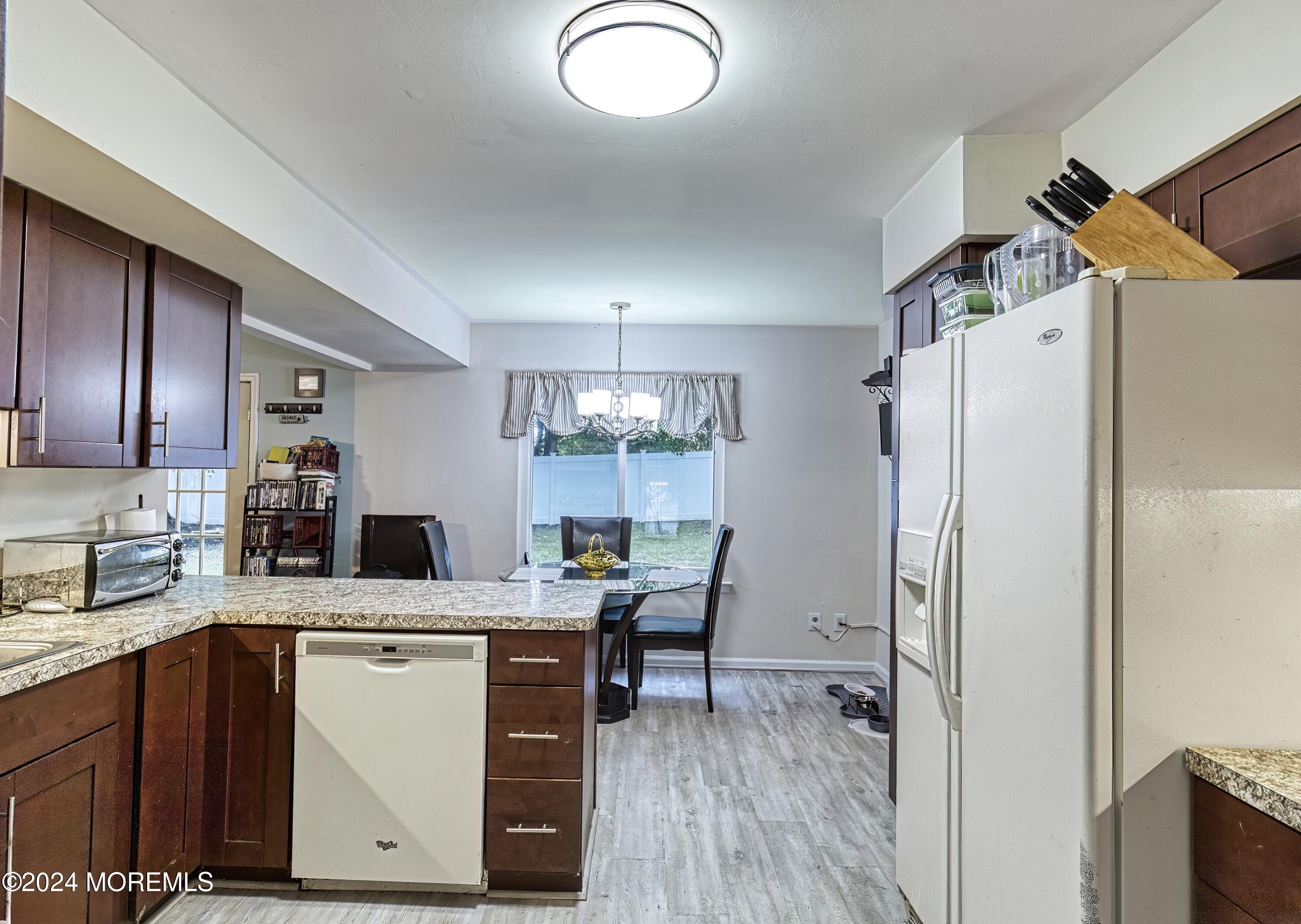 34 Sweetbriar Trail Howell, NJ 07731 - Photo 44 of 53 a kitchen with a refrigerator a sink and wooden cabinets
