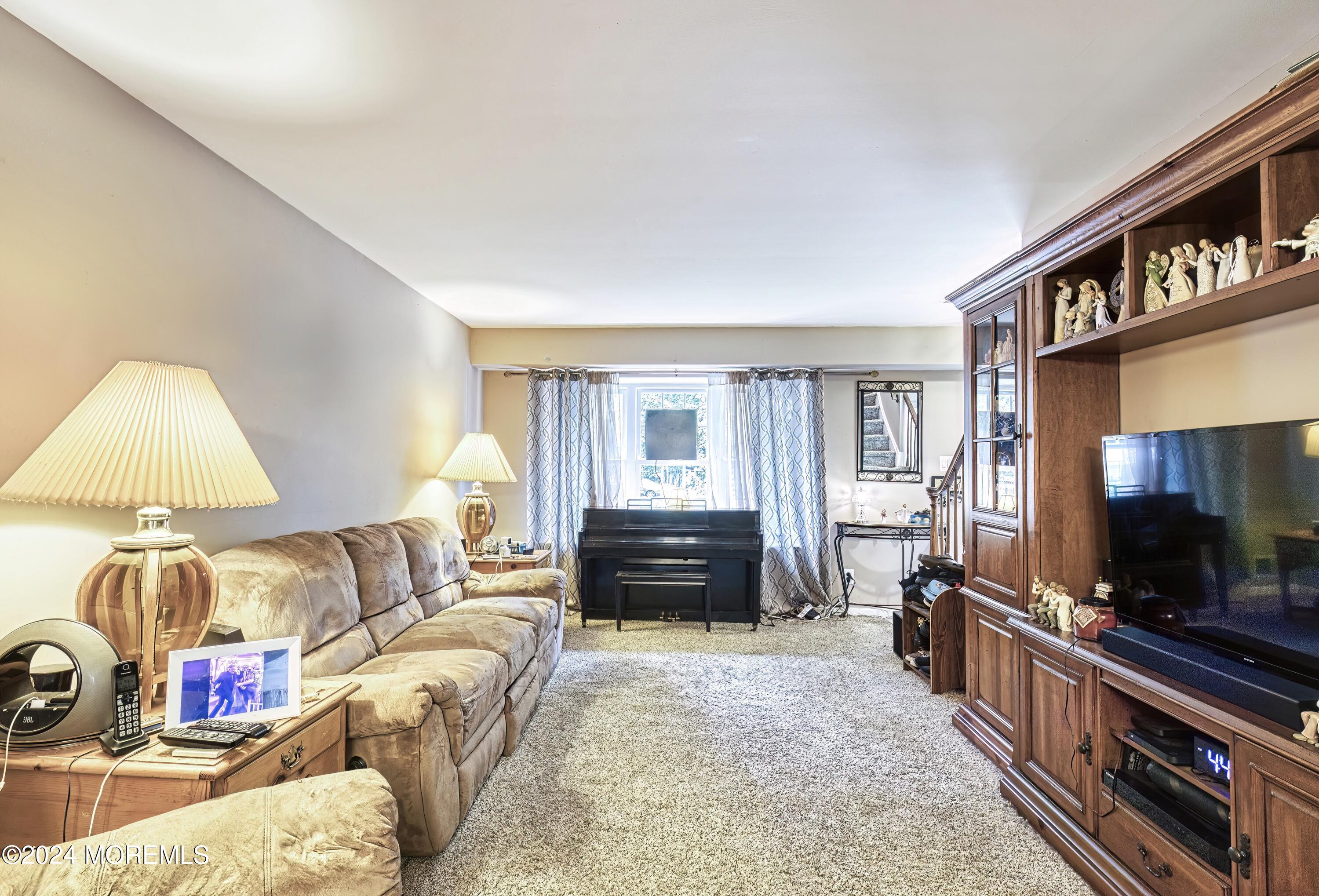 34 Sweetbriar Trail Howell, NJ 07731 - Photo 49 of 53 a living room with furniture and a flat screen tv