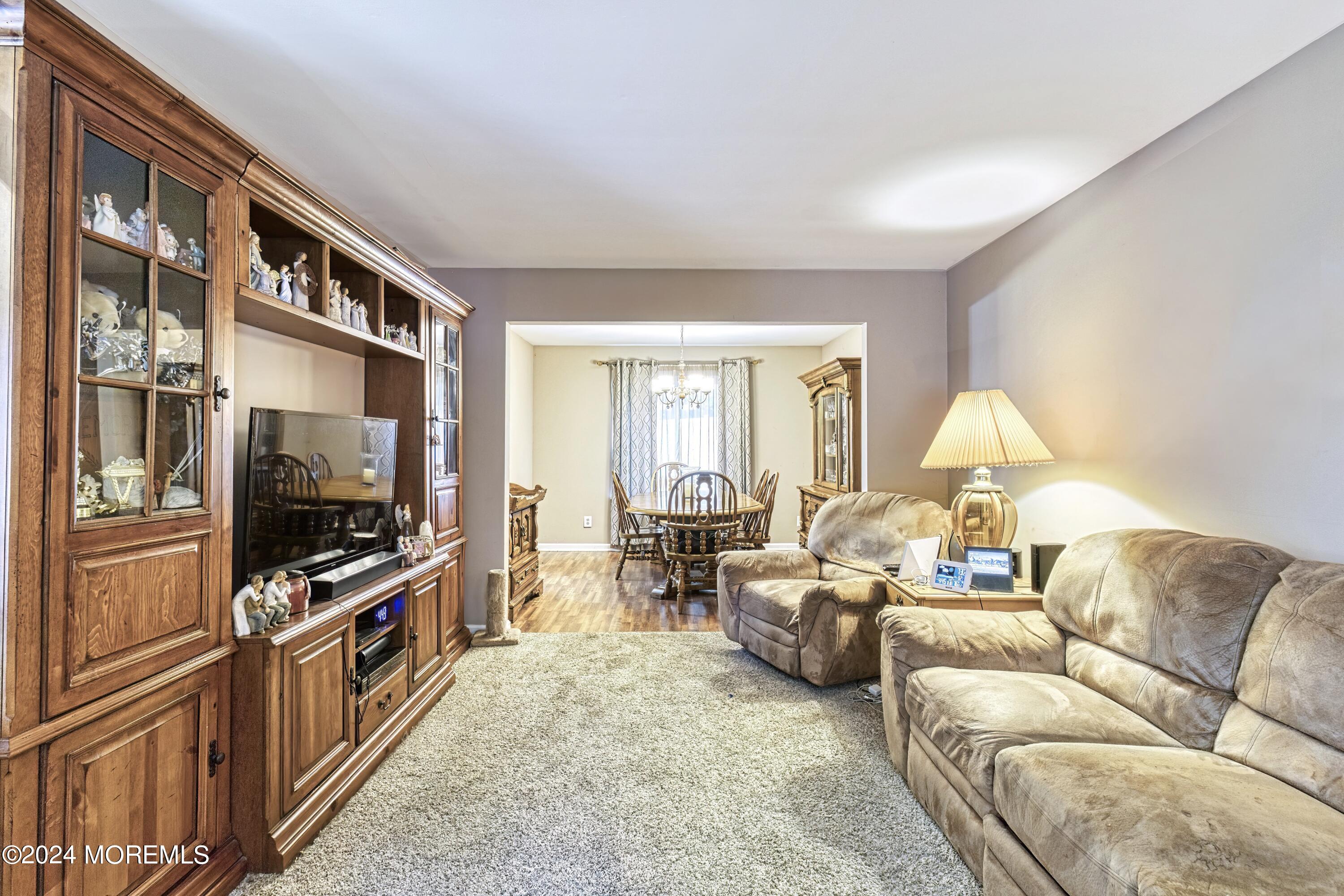 34 Sweetbriar Trail Howell, NJ 07731 - Photo 52 of 53 a living room with furniture and a flat screen tv