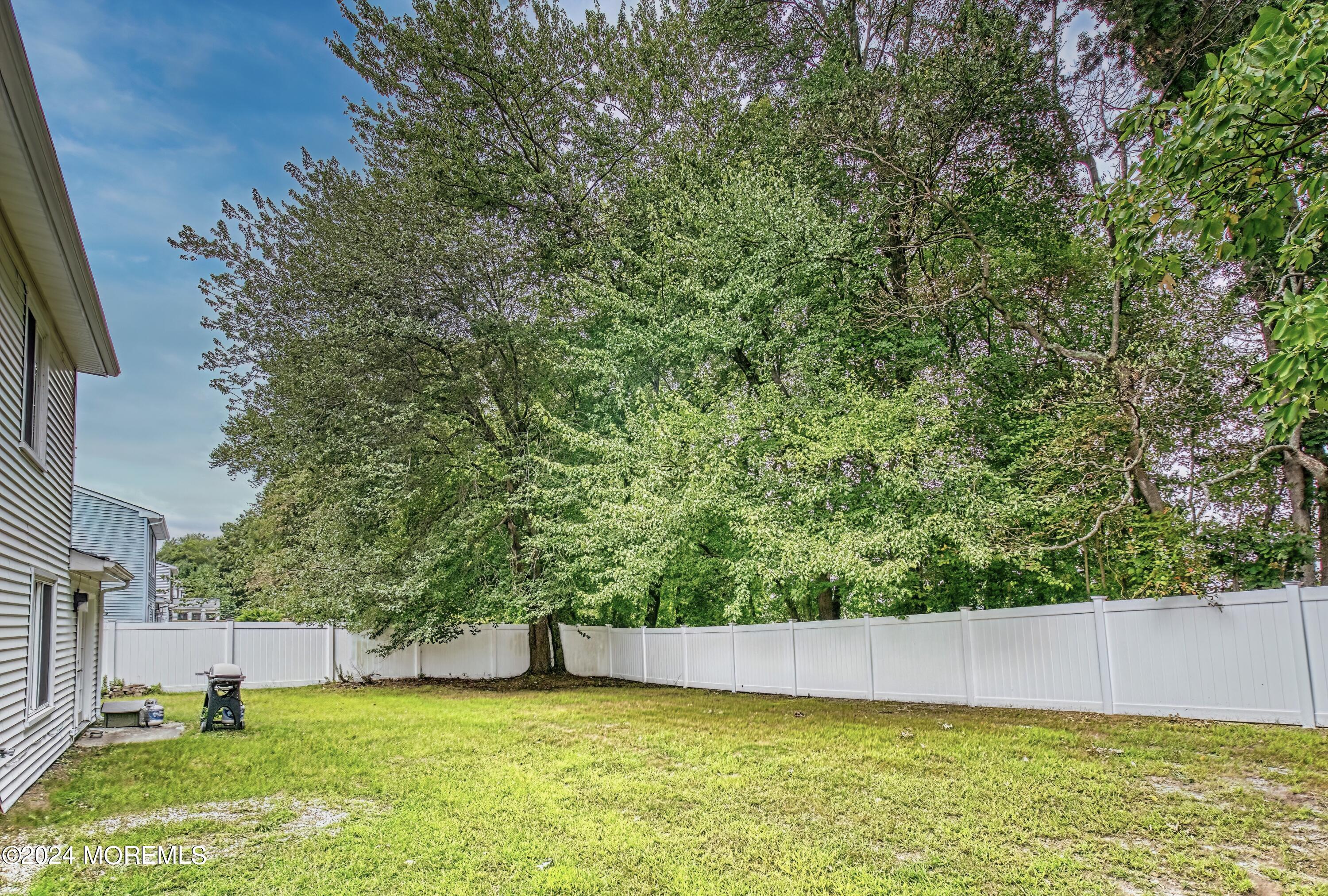 34 Sweetbriar Trail Howell, NJ 07731 - Photo 10 of 53 a view of a swimming pool and trees in the background