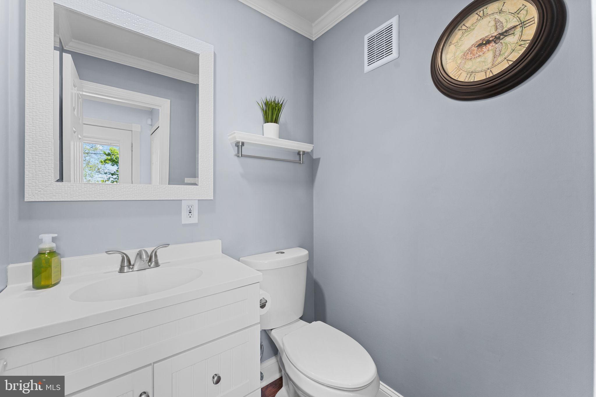 418 Harrison Street Riverside, NJ 08075 - Photo 11 of 29 a bathroom with a toilet sink and mirror
