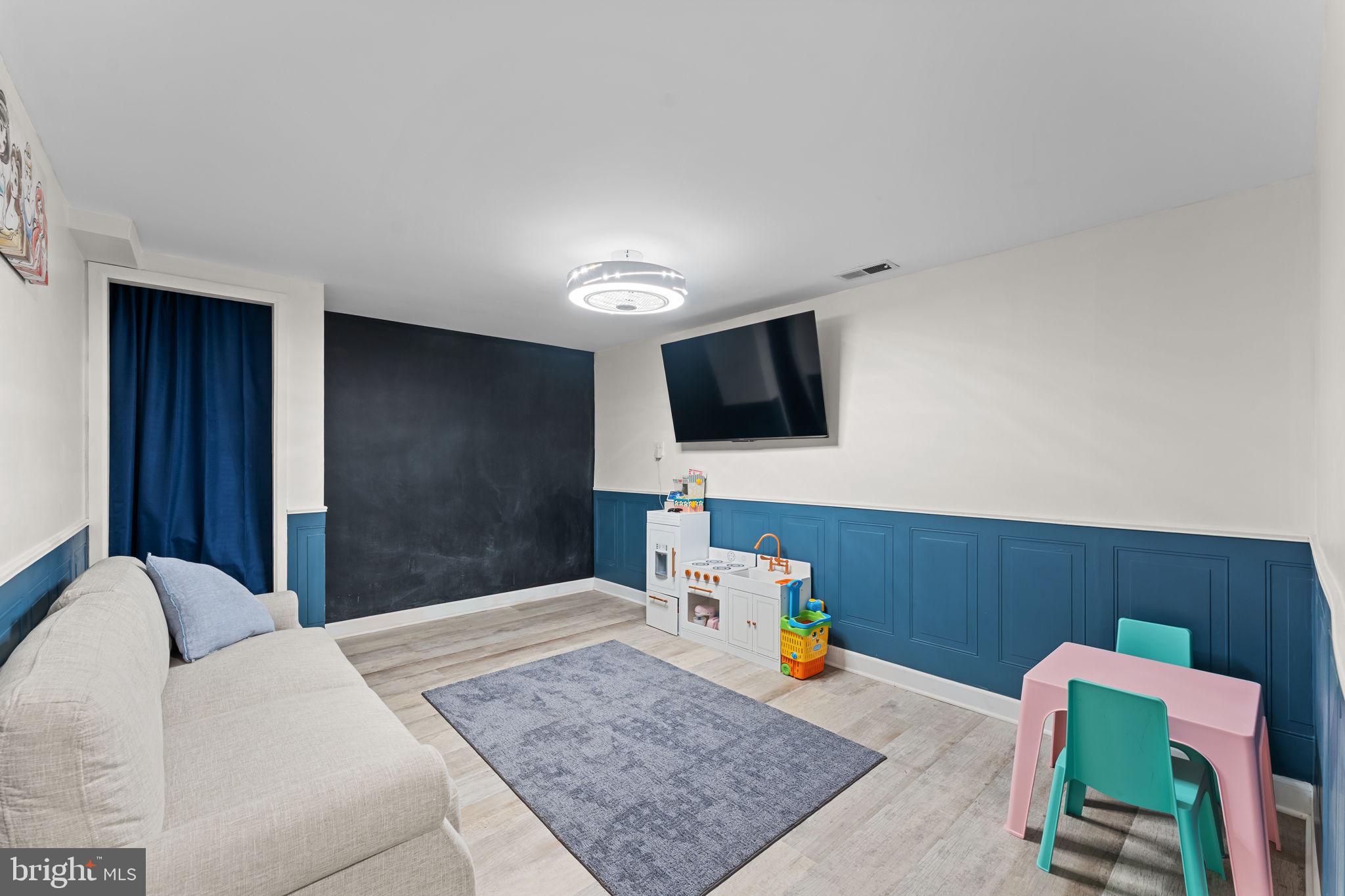 418 Harrison Street Riverside, NJ 08075 - Photo 20 of 29 a bedroom with furniture and a flat screen tv