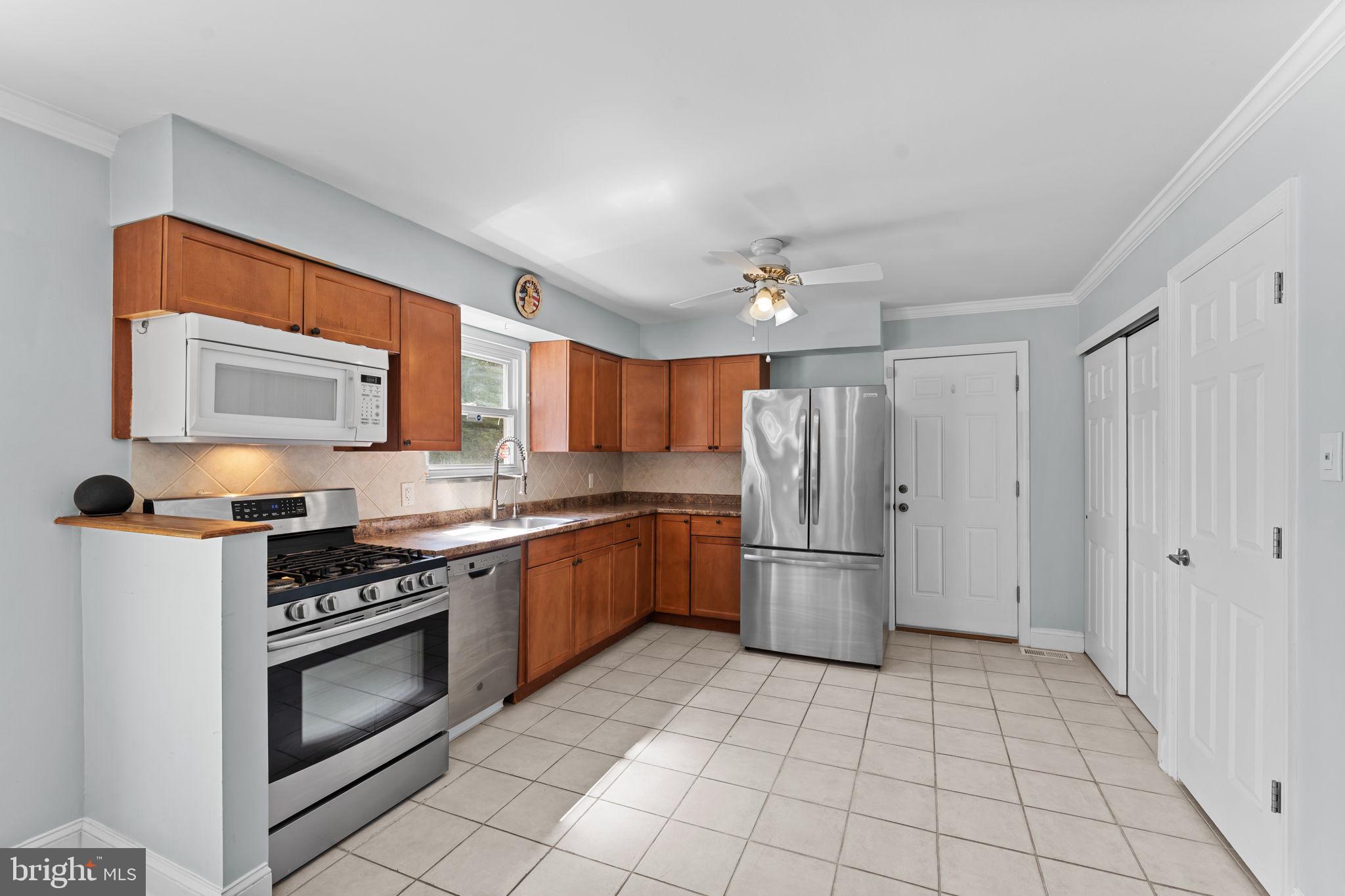 418 Harrison Street Riverside, NJ 08075 - Photo 8 of 29 a kitchen with a stove top oven and cabinets