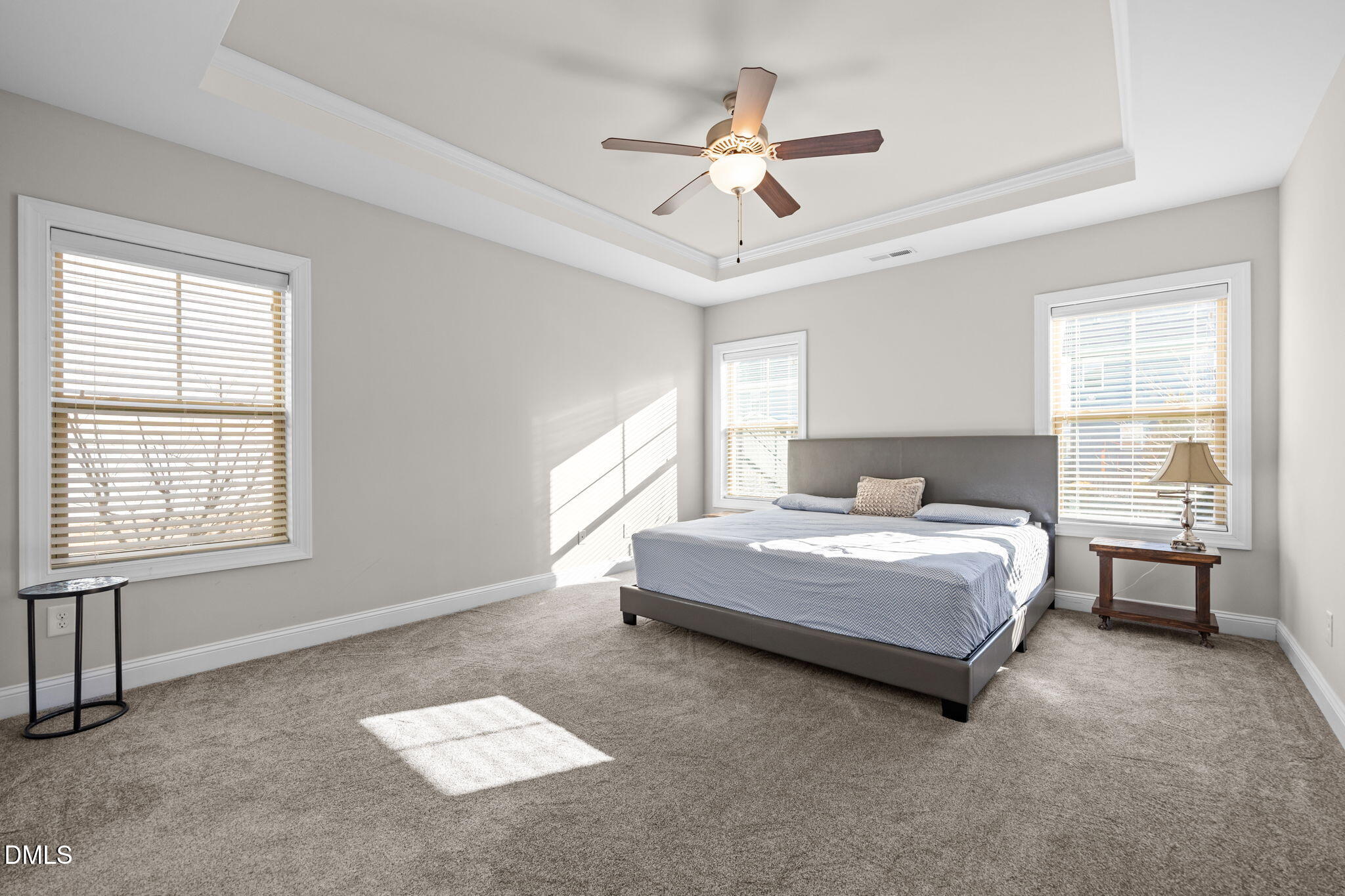 3528 Jones Lake Road Fuquay-Varina, NC 27526 - Photo 21 of 50 a bedroom with a large bed chandelier and window