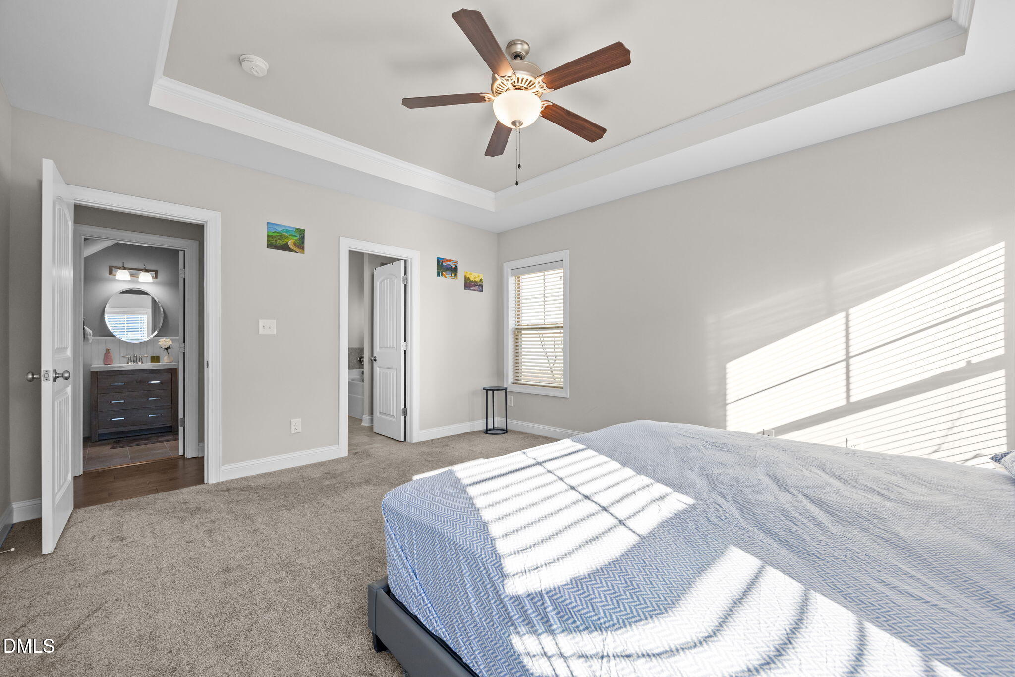 3528 Jones Lake Road Fuquay-Varina, NC 27526 - Photo 22 of 50 a bedroom with a bed ceiling fan and a large window