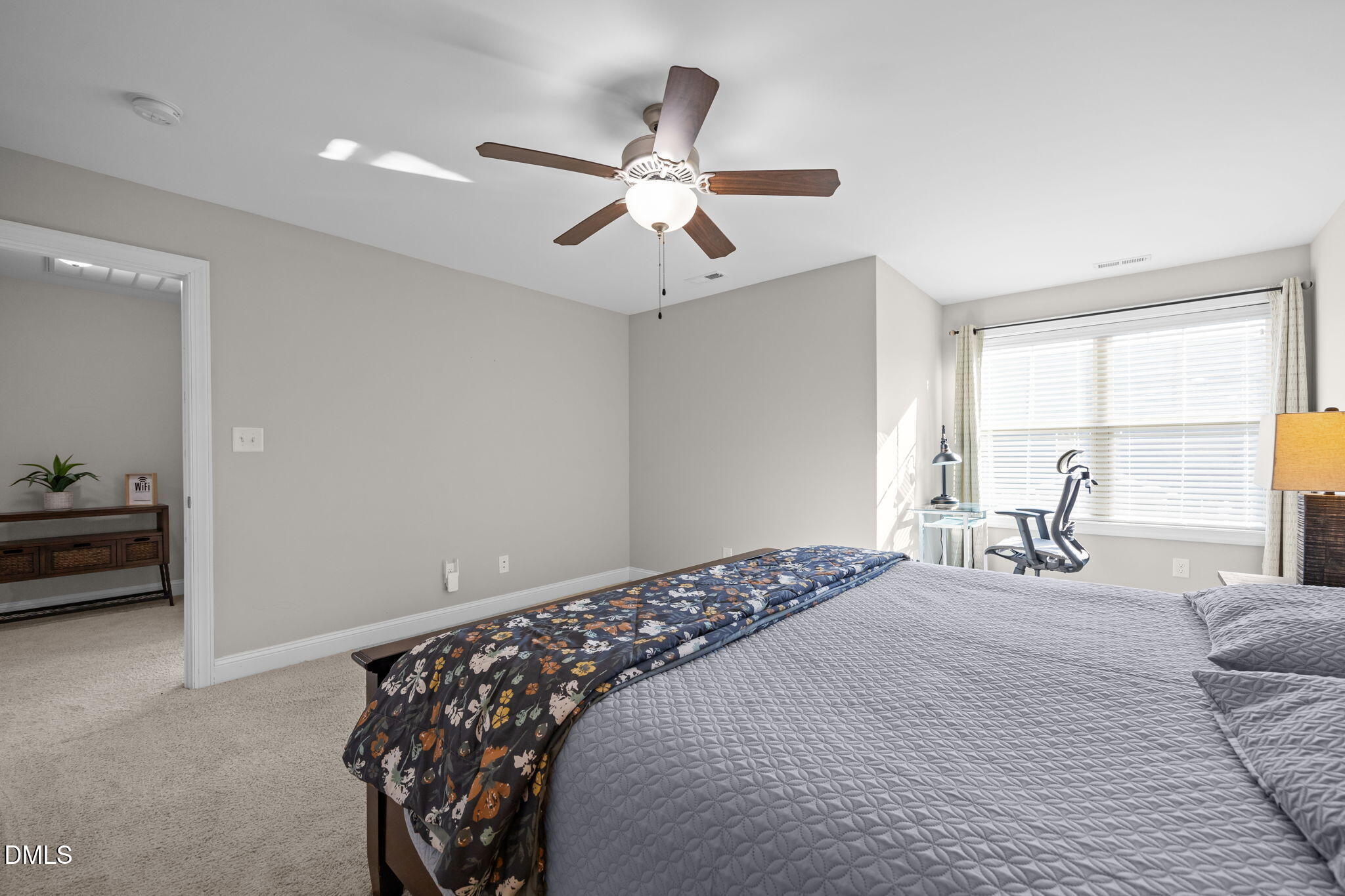 3528 Jones Lake Road Fuquay-Varina, NC 27526 - Photo 35 of 50 a bedroom with a bed and a chandelier