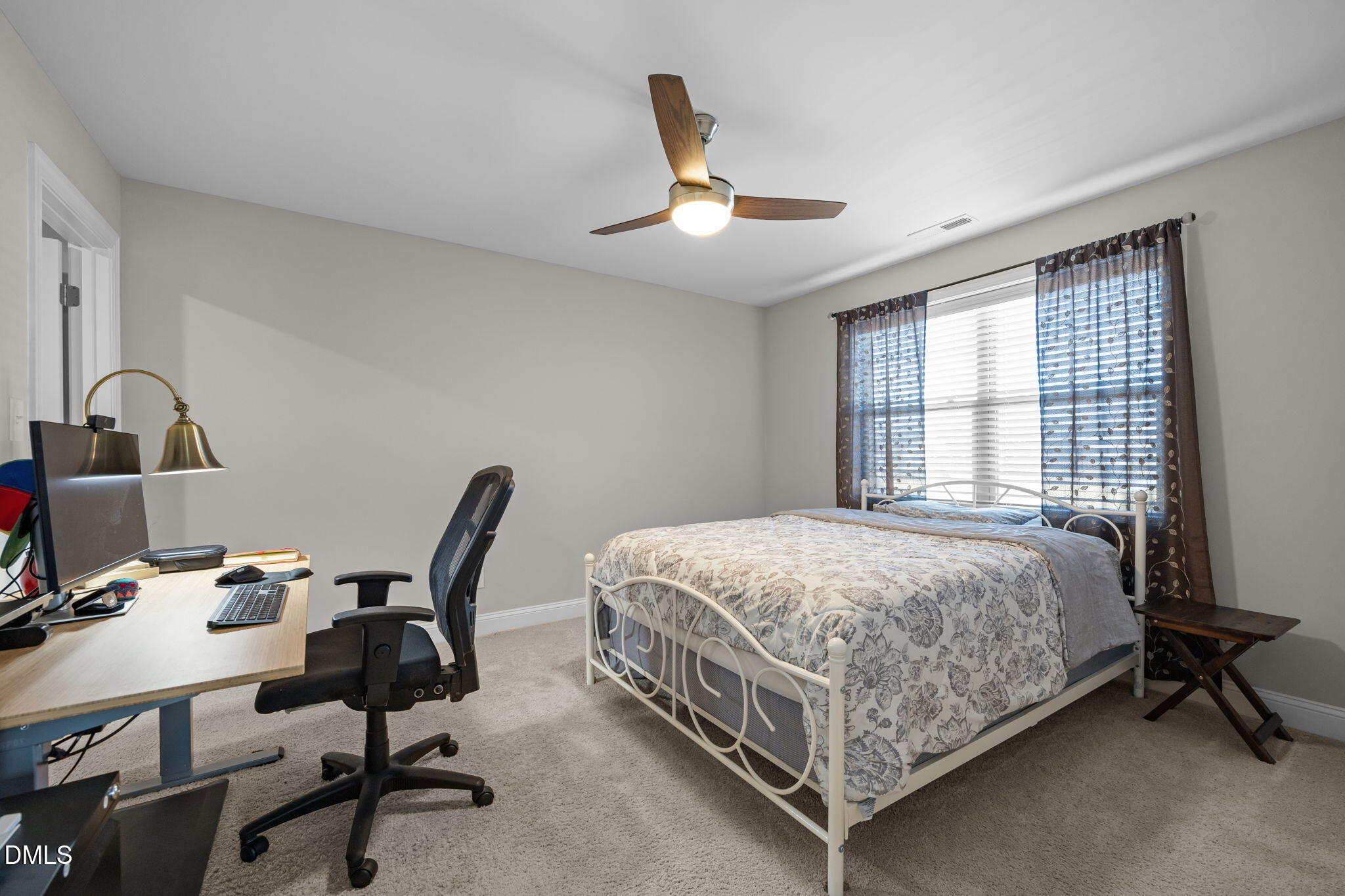 3528 Jones Lake Road Fuquay-Varina, NC 27526 - Photo 36 of 50 a bedroom with a bed a desk and chair with window