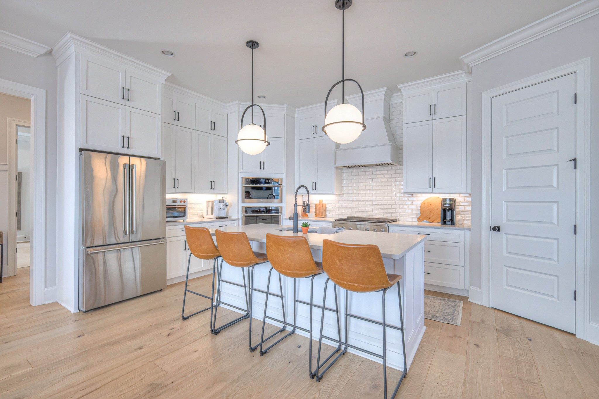 2042 Nathaniel Road Franklin, TN 37064 - Photo 12 of 40 a kitchen with stainless steel appliances granite countertop a sink a stove a refrigerator and island with wooden floor