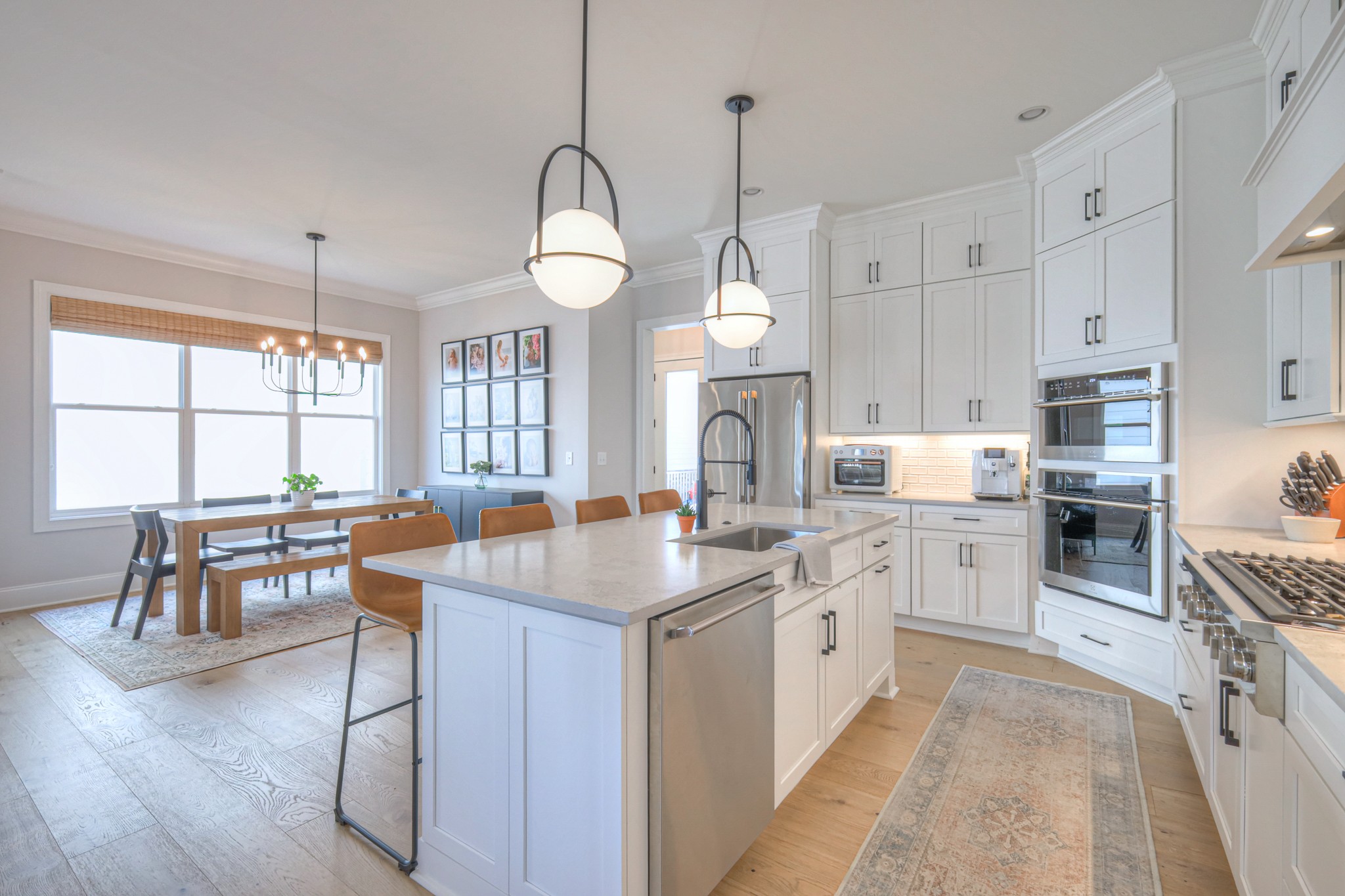 2042 Nathaniel Road Franklin, TN 37064 - Photo 14 of 40 a kitchen with stainless steel appliances granite countertop a stove oven a sink a dining table and chairs with wooden floor