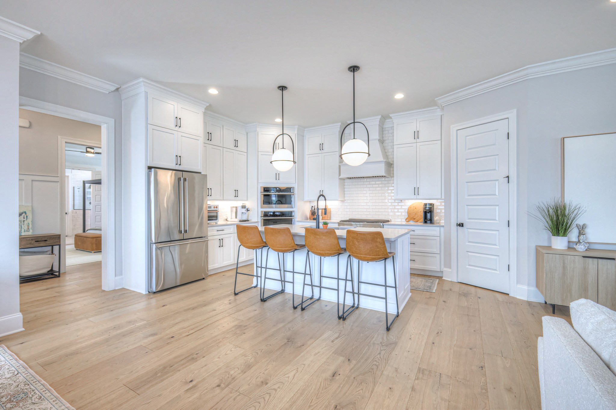 2042 Nathaniel Road Franklin, TN 37064 - Photo 16 of 40 a kitchen with stainless steel appliances a refrigerator a stove a sink dishwasher and a dining table with wooden floor