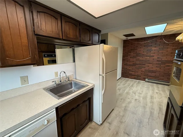 a kitchen with stainless steel appliances a refrigerator and a sink
