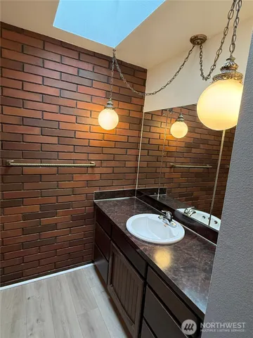 a bathroom with a sink a mirror and shower