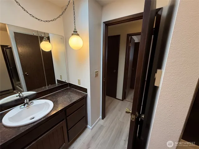 a bathroom with a granite countertop sink and a mirror