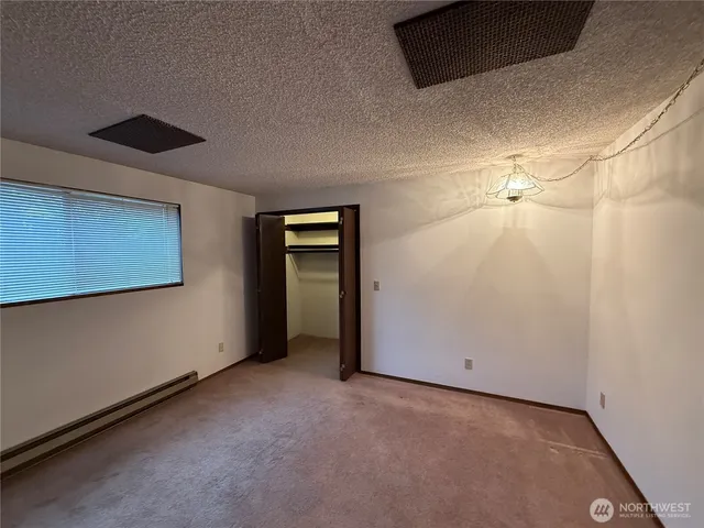 a view of an empty room with a bathroom