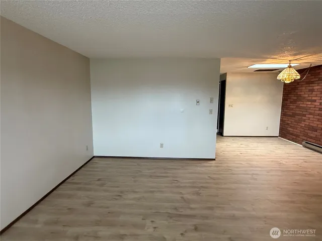 a view of an empty room and wooden floor