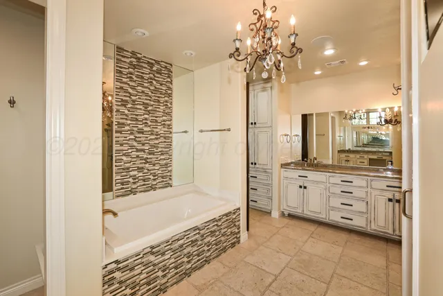 a bathroom with a granite countertop sink toilet and mirror