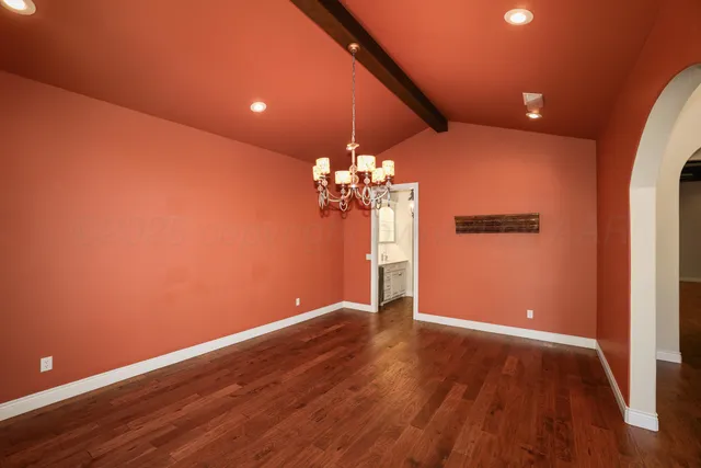 a view of a room with wooden floor