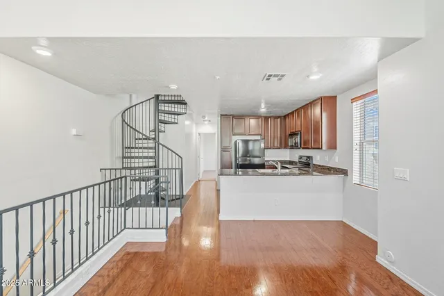 a view of a kitchen with wooden floor