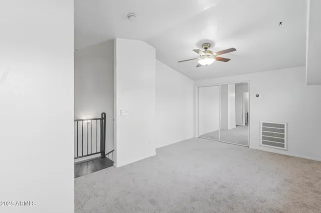 a view of empty room with ceiling fan