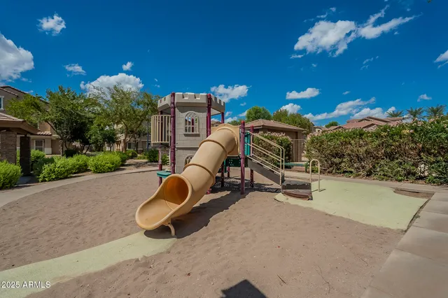 a backyard of a house with table and chairs