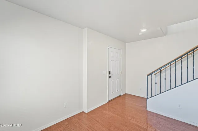 a view of hallway with wooden floor