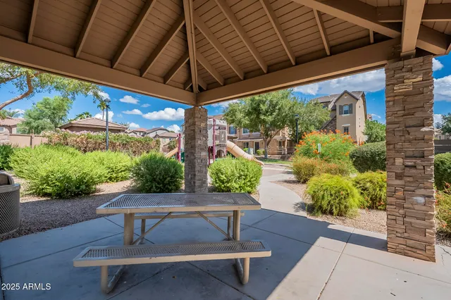 a view of a patio with table and chairs potted plants