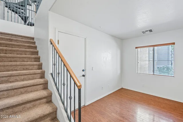 a view of entryway with wooden floor and stairs