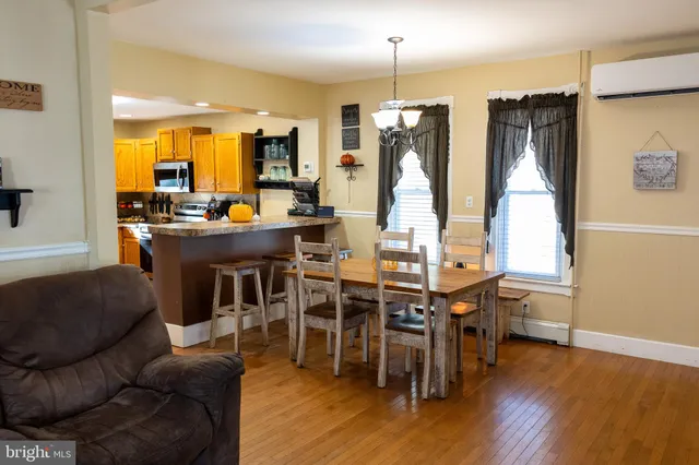 a view of a dining room with furniture and wooden floor