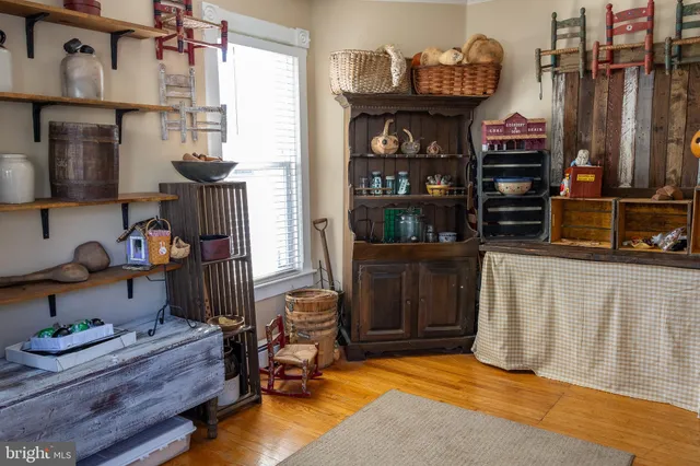 a view of hall way with furniture and closet