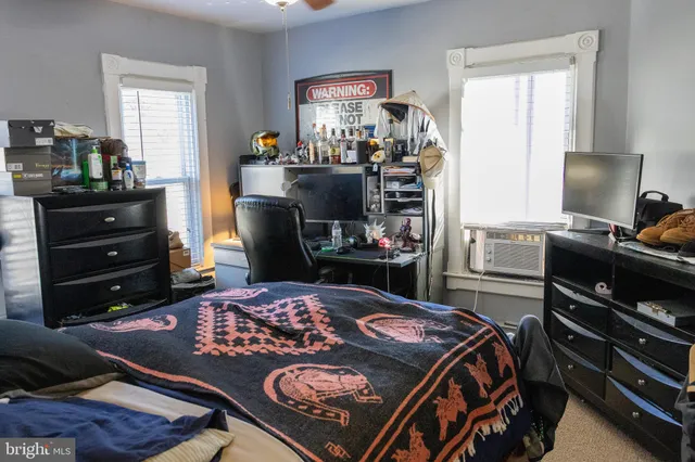 a bed room with a bed and a television