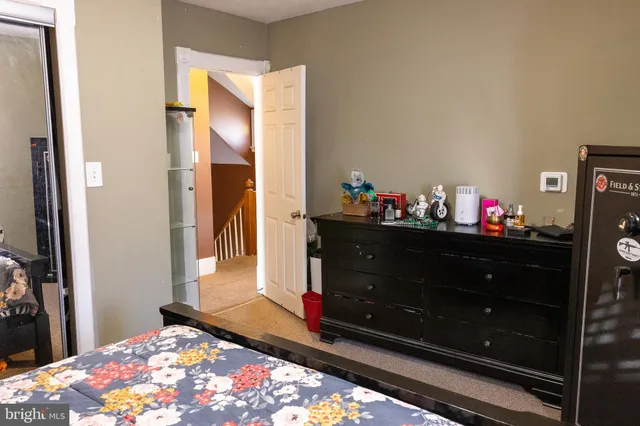 a bedroom with a bed and a dresser