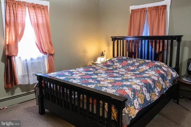 a bed sitting in a bedroom next to a window