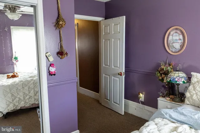 a very nice looking room with a red couch and a chandelier