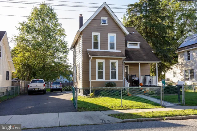 a front view of a house with a yard table and chairs